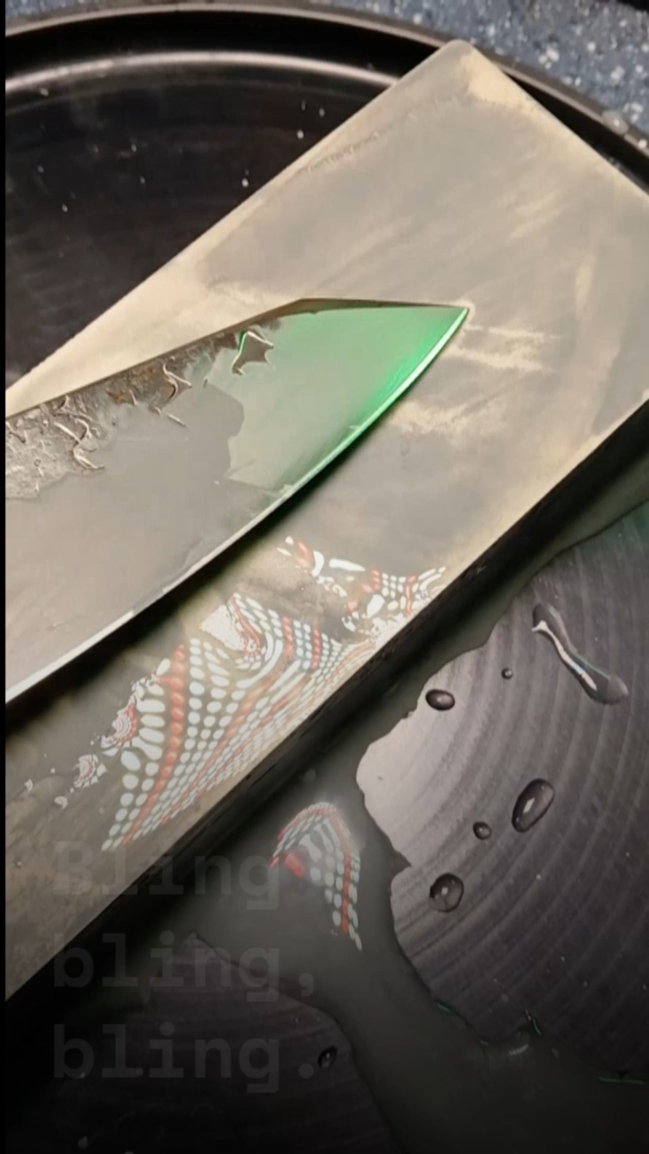 Freshly sharpened knife on whetstone — precision bevel reflection